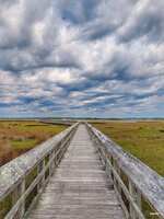 Marsh Boardwalk Under Stormy Skies