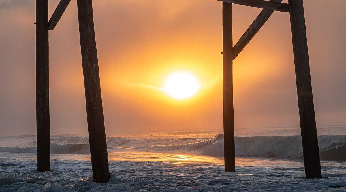 Sunrise Between the Pier Pilings