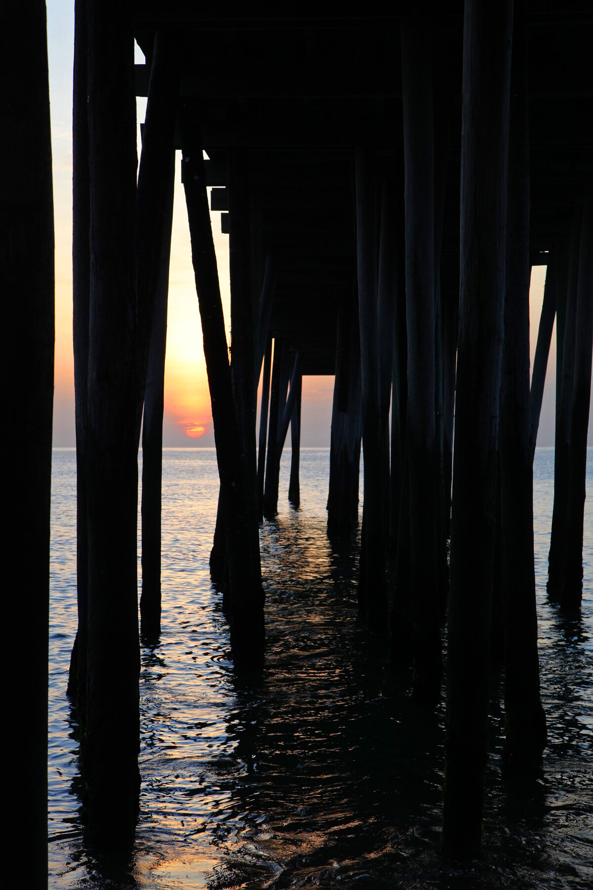 Sunset Beneath the Pier Pilings