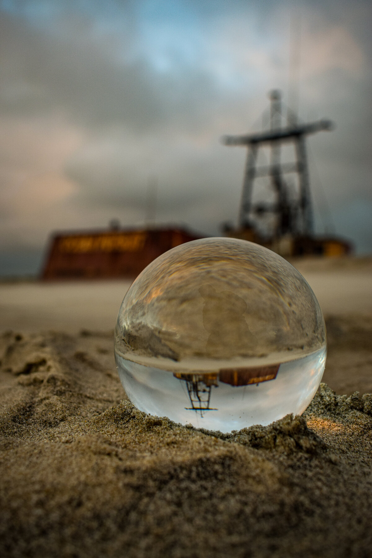 Old Rig Reflected in a Glass Sphere